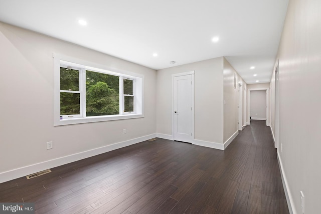 empty room with dark hardwood / wood-style floors