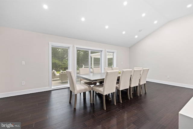 dining area featuring vaulted ceiling and dark wood-type flooring