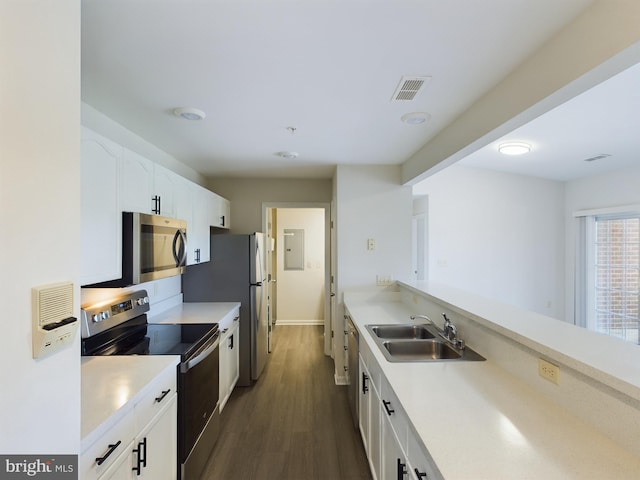 kitchen featuring dark hardwood / wood-style floors, stainless steel appliances, white cabinets, and sink