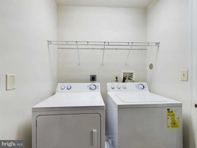 clothes washing area with washer and dryer