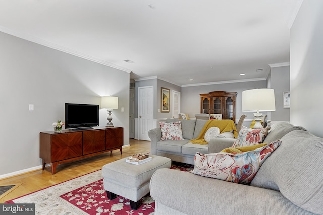 living room featuring crown molding and light hardwood / wood-style flooring