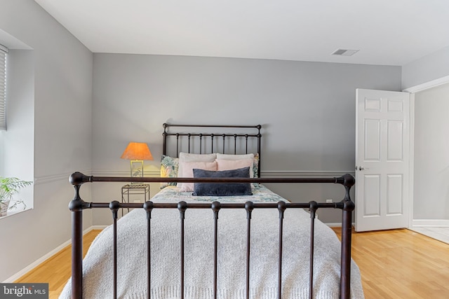 bedroom with hardwood / wood-style flooring