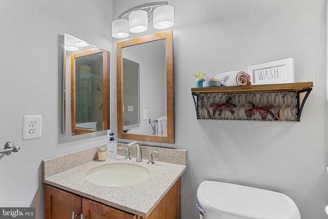 bathroom featuring toilet and vanity