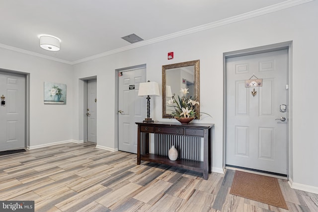 entryway featuring ornamental molding and light wood-type flooring