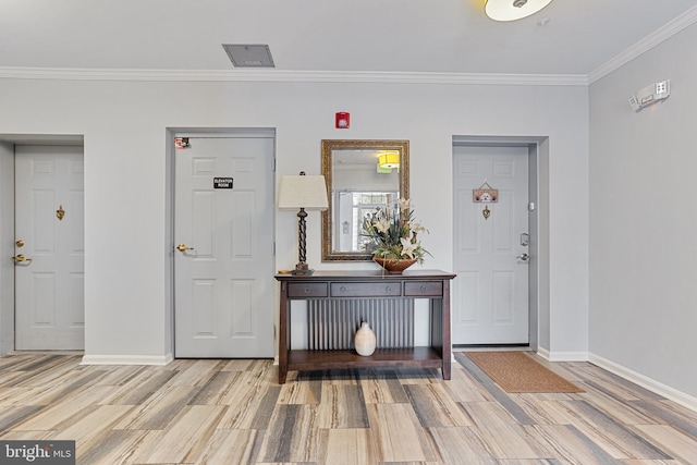 entrance foyer featuring light hardwood / wood-style floors and crown molding