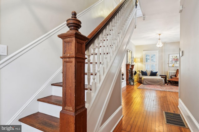 stairs with hardwood / wood-style floors