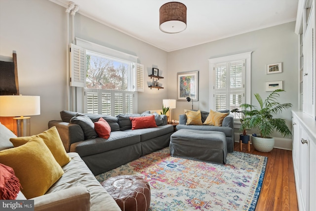 living room featuring crown molding, plenty of natural light, and dark hardwood / wood-style floors