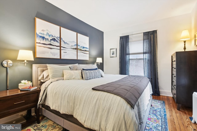 bedroom with wood-type flooring