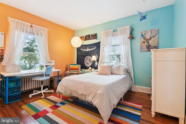 bedroom with radiator and dark wood-type flooring