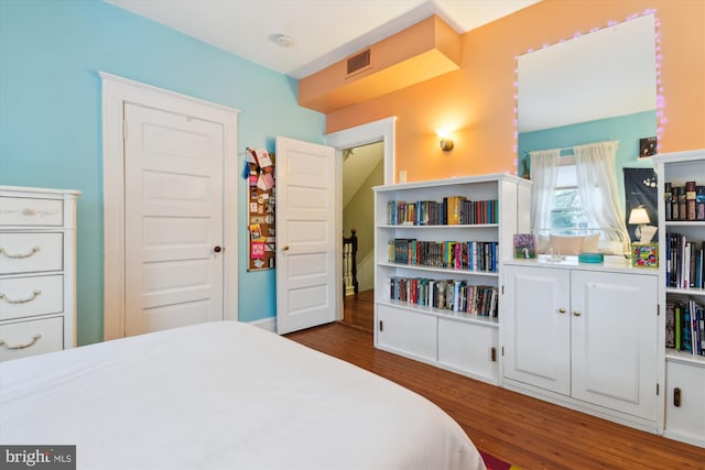 bedroom featuring dark hardwood / wood-style flooring