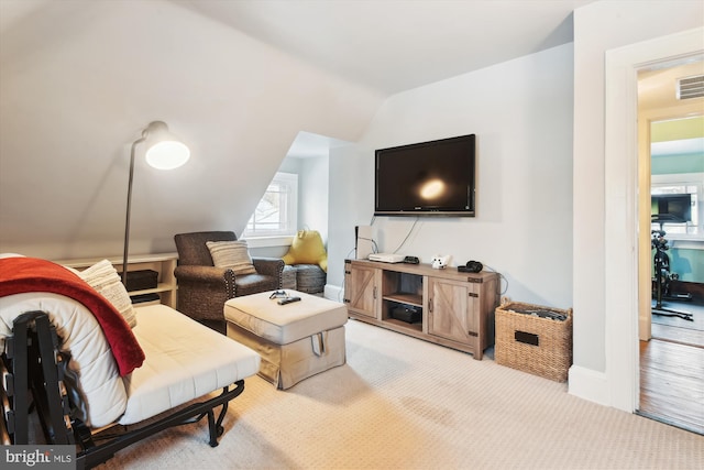 carpeted living room featuring lofted ceiling