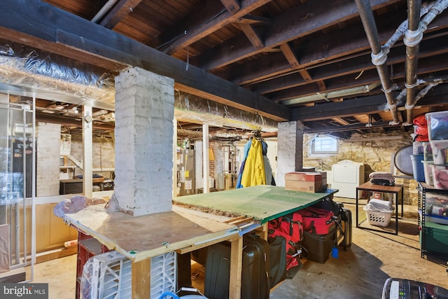 basement with gas water heater and washing machine and dryer