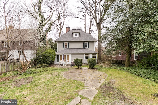 view of front of home with a patio area and a front lawn