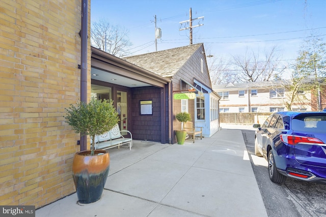 view of property exterior with a patio area