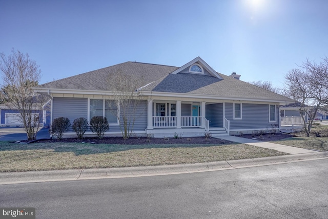 view of front of home with a front yard and covered porch