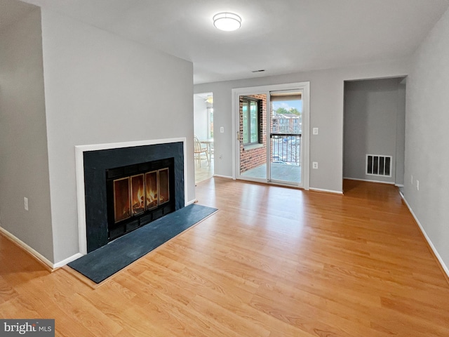 unfurnished living room with light hardwood / wood-style flooring