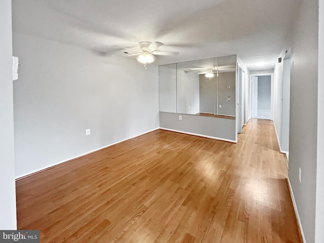 spare room with ceiling fan and light hardwood / wood-style flooring