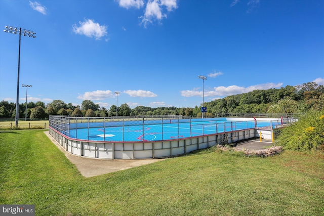 view of pool with a yard