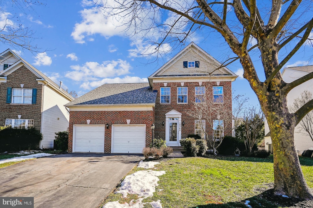 view of front property featuring a garage and a front lawn