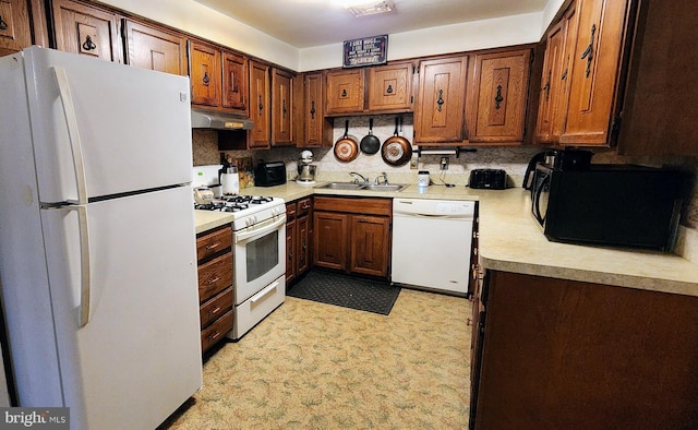 kitchen featuring tasteful backsplash, sink, and white appliances