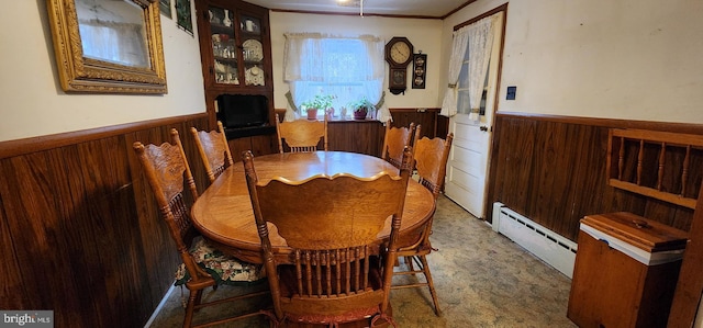 carpeted dining space with ornamental molding and a baseboard radiator