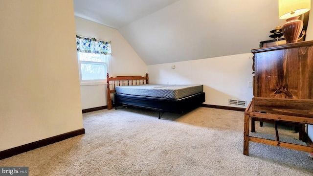 bedroom featuring light carpet and vaulted ceiling