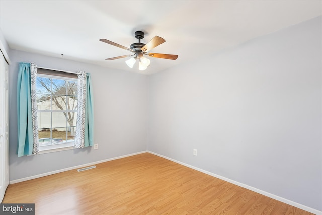 empty room with hardwood / wood-style flooring and ceiling fan