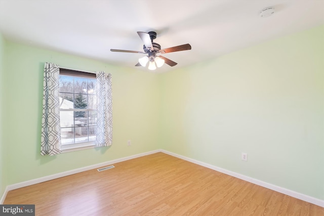 empty room featuring ceiling fan, light hardwood / wood-style flooring, and plenty of natural light