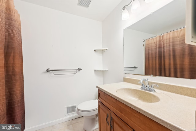 bathroom with toilet, tile patterned floors, and vanity