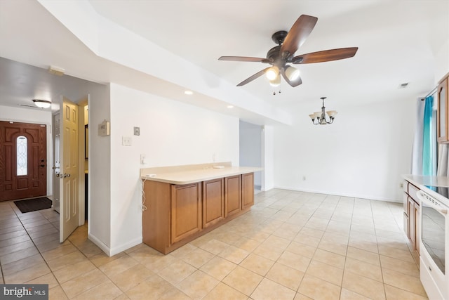 kitchen with hanging light fixtures, light tile patterned flooring, a healthy amount of sunlight, ceiling fan with notable chandelier, and white electric range