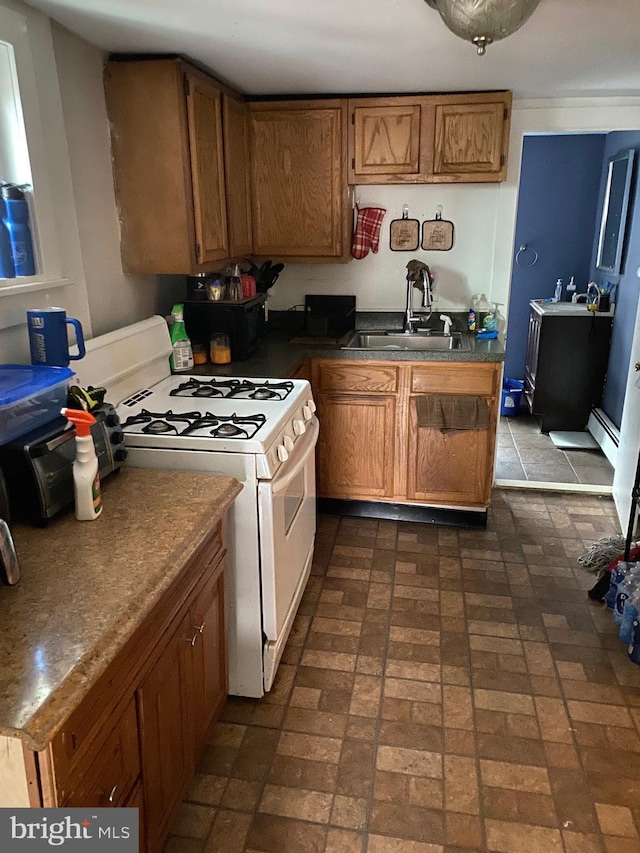 kitchen with sink, white range with gas stovetop, and baseboard heating