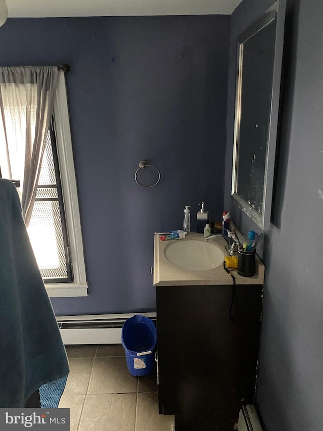 bathroom with tile patterned floors, vanity, and a baseboard heating unit