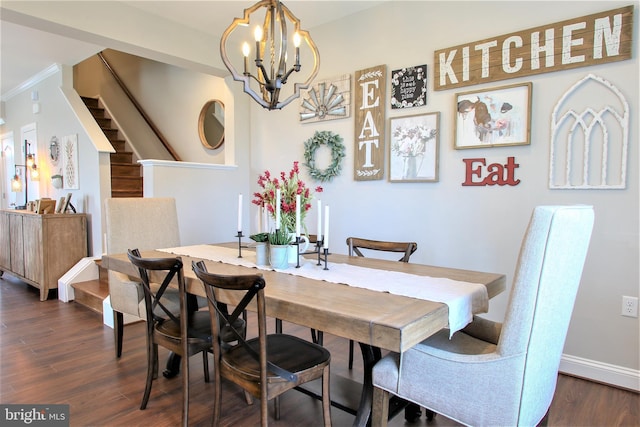 dining room featuring dark hardwood / wood-style flooring, a chandelier, and ornamental molding