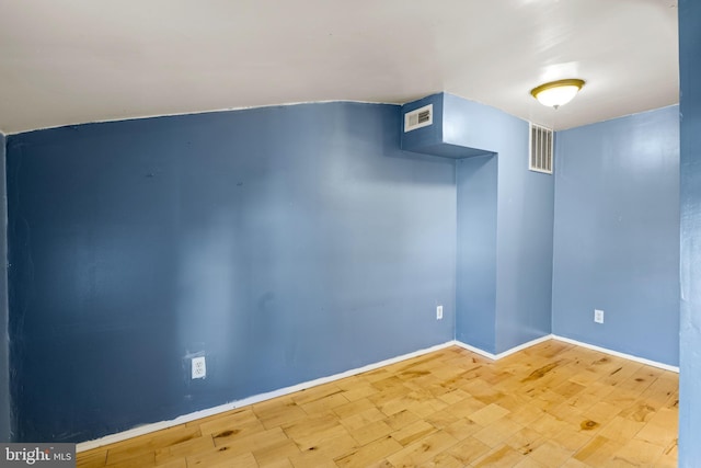 spare room with hardwood / wood-style floors