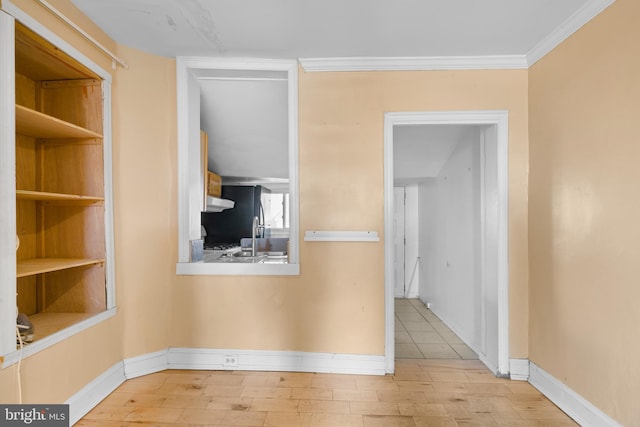 corridor featuring light wood-type flooring and ornamental molding