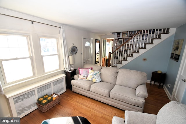 living room featuring radiator heating unit and hardwood / wood-style floors