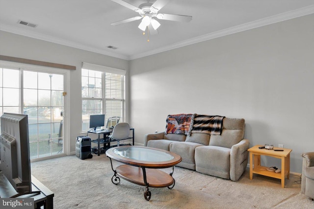 living room featuring ceiling fan, light colored carpet, and crown molding