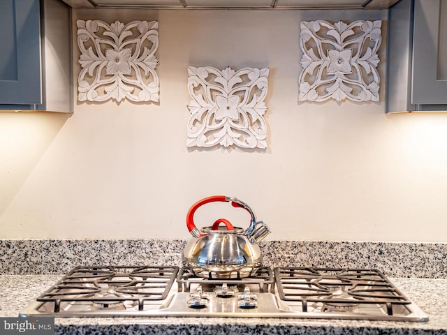 room details with gray cabinetry and stainless steel gas cooktop