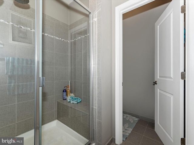 bathroom featuring walk in shower and tile patterned flooring