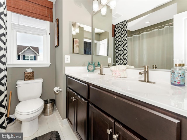 bathroom featuring tile patterned flooring, vanity, a shower with curtain, and toilet