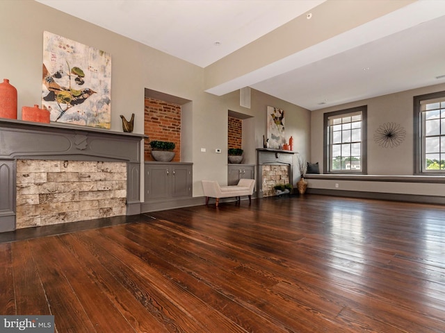 unfurnished room with beam ceiling and dark hardwood / wood-style floors