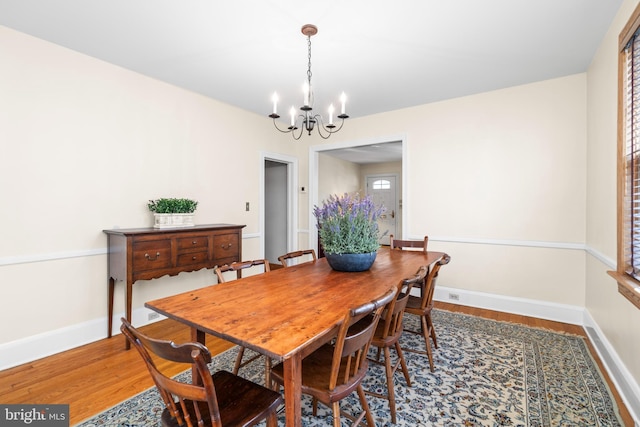 dining room with an inviting chandelier and wood-type flooring