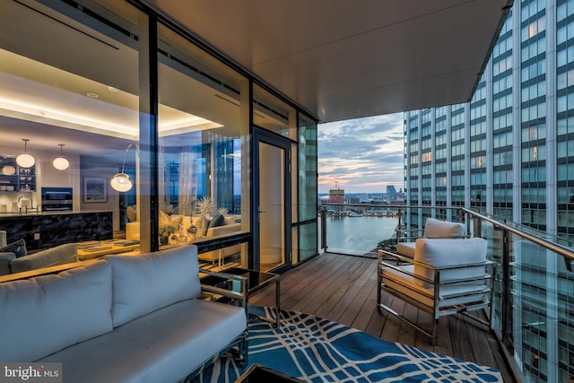 300 International Dr Unit 2303, Baltimore, MD 21202 - balcony at dusk with an outdoor living space, a water view, and sink