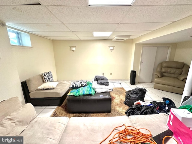 tiled living room featuring a paneled ceiling