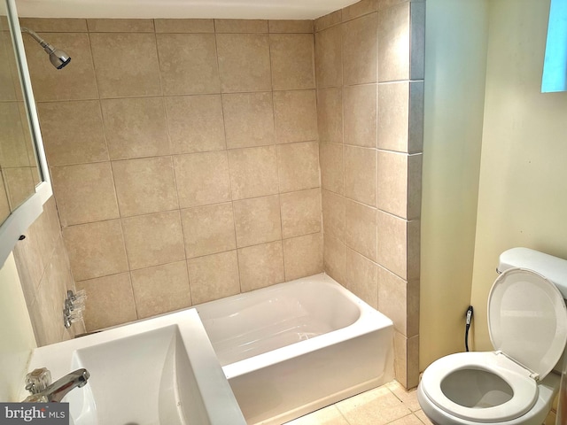 bathroom with toilet, tiled shower / bath combo, and tile patterned floors