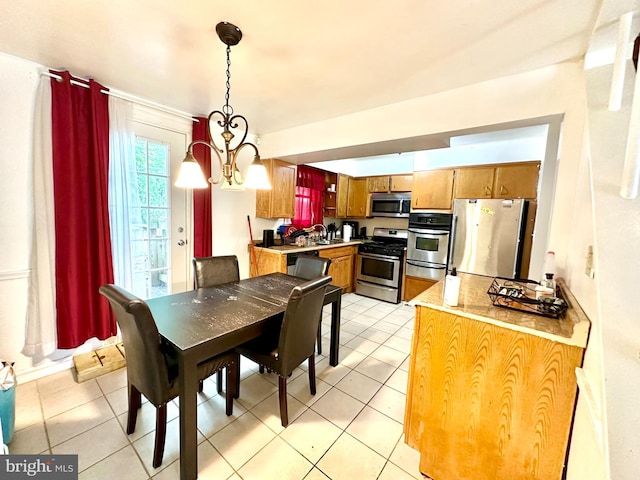 tiled dining space with a chandelier and sink