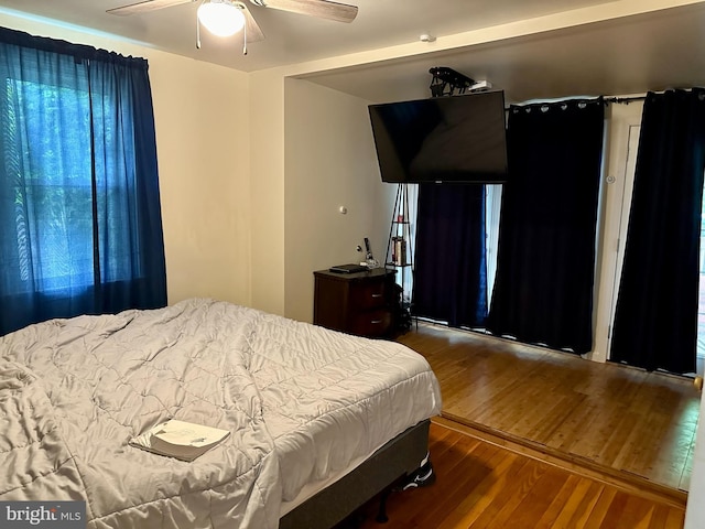 bedroom with ceiling fan and wood-type flooring