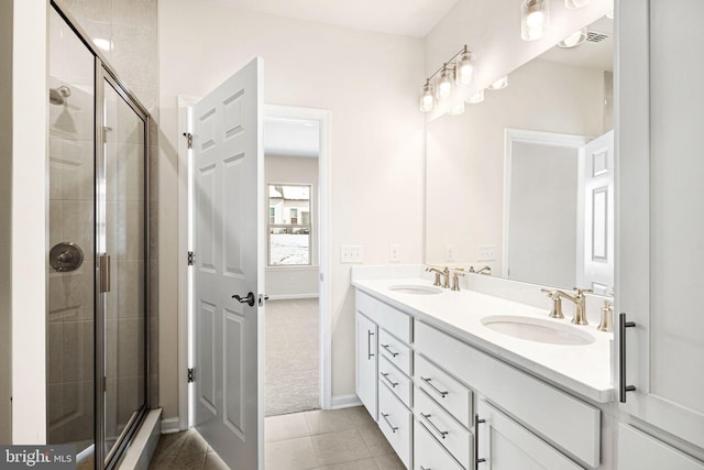 bathroom with tile patterned flooring, vanity, and walk in shower