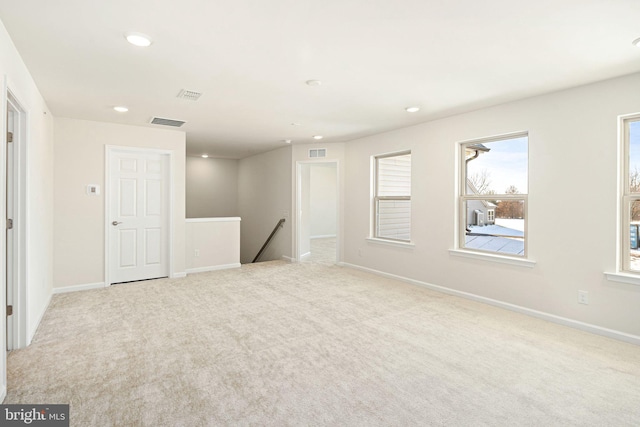 unfurnished room with light carpet