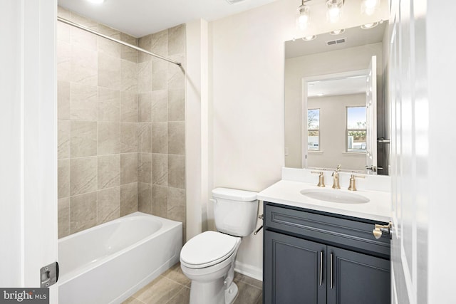 full bathroom with tile patterned floors, vanity, toilet, and tiled shower / bath combo